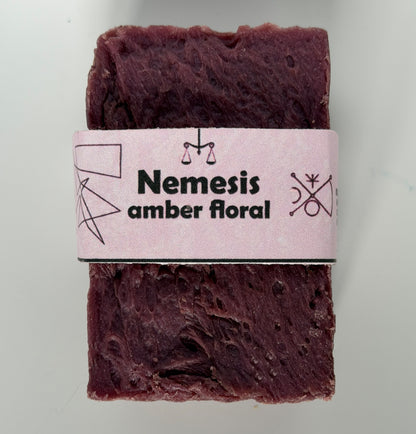 Coral-rose handmade soap bar with swirled rustic texture, wrapped in a vintage carnival-style yellow and cream band reading "Shiny Boy – Tropical Gourmand"