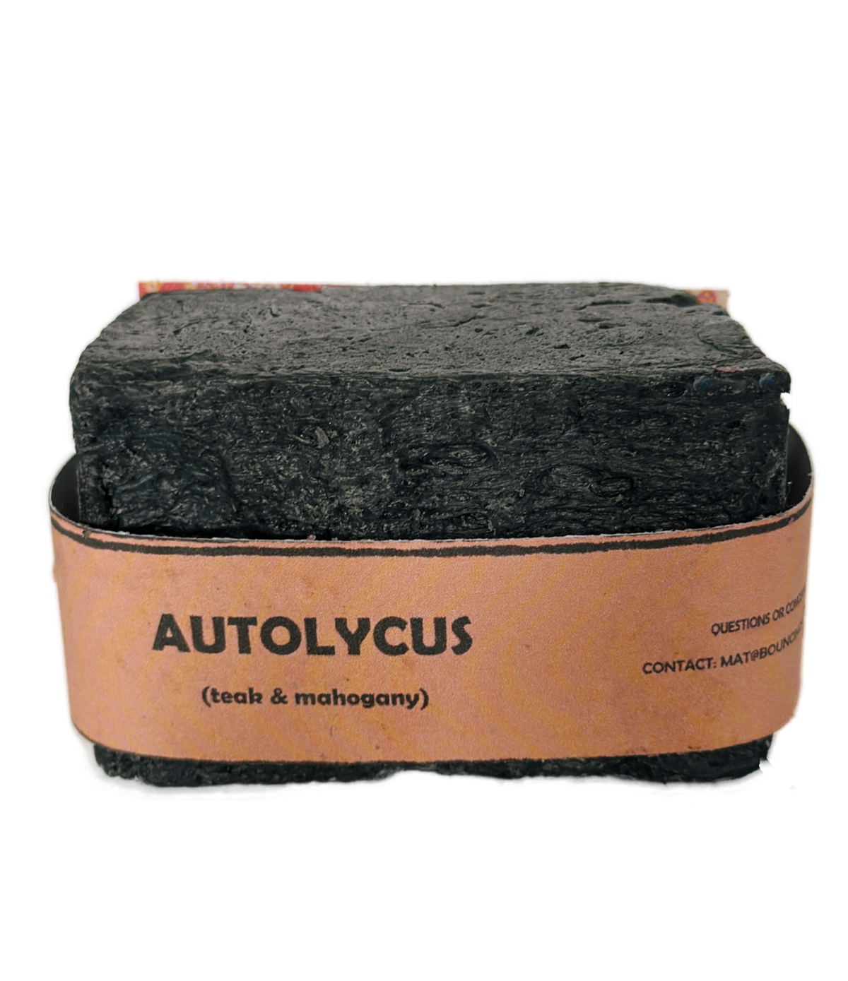 Single bar of Autolycus handmade soap by Bouncing Studio showing dark black texture