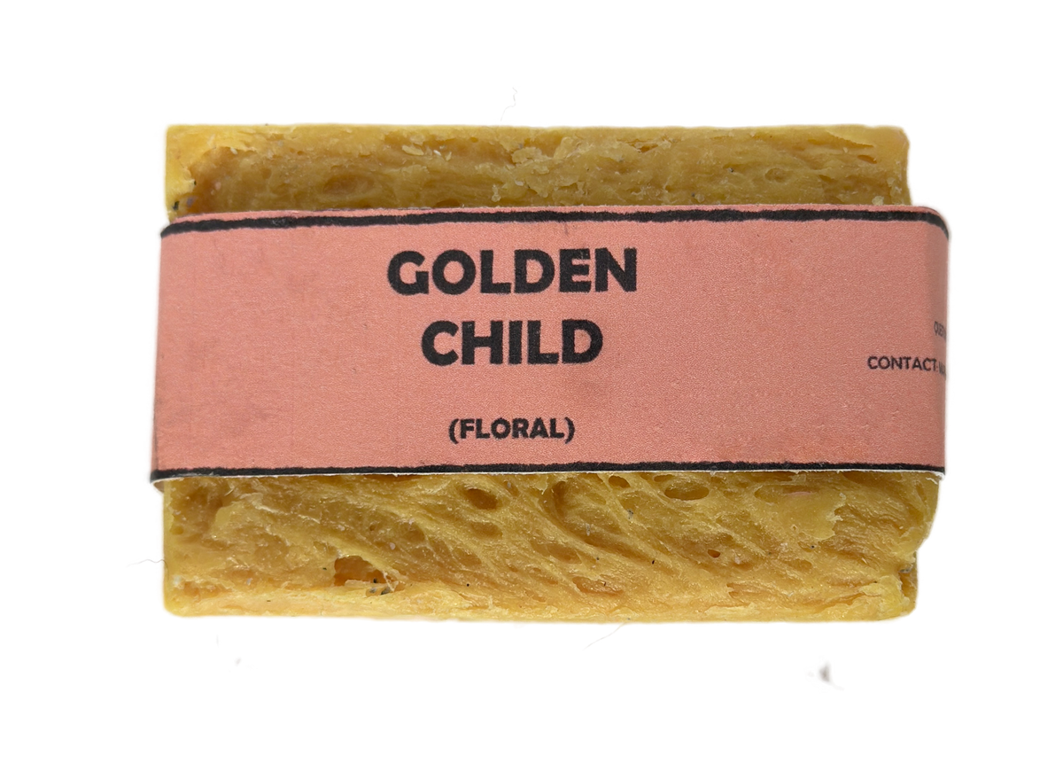Golden Child floral handmade soap bar by Bouncing Studio showing golden yellow rustic texture from above on white background