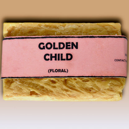 Golden Child floral handmade soap bar by Bouncing Studio showing golden yellow rustic texture from above on white background