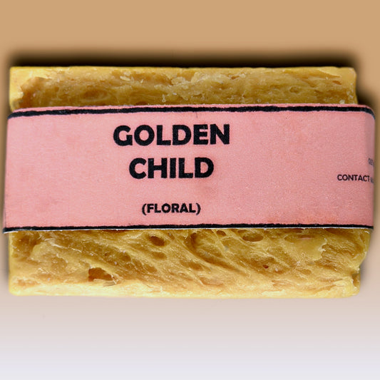 Golden Child floral handmade soap bar by Bouncing Studio showing golden yellow rustic texture from above on white background